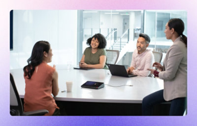  A group of employees discussing something while smiling.