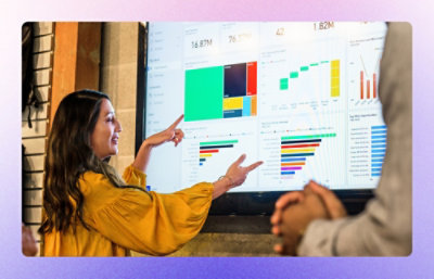 A woman giving presentation using a big screen.
