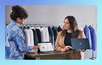 Two people reviewing data on a laptop in a retail studio.
