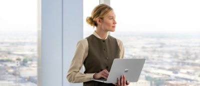 Professional using a laptop by a window