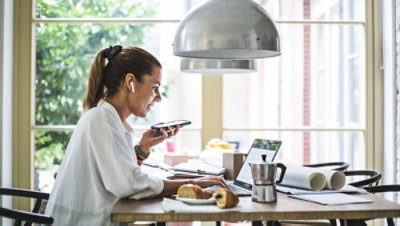 A person sitting at a table using a computer