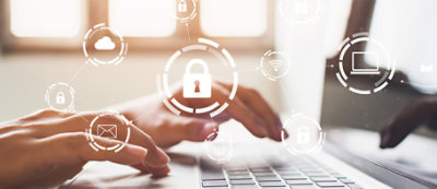 Hands typing on a laptop keyboard, overlaid with security icons including a padlock, cloud, email, and wifi symbols, representing cybersecurity.