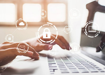 Hands typing on a laptop keyboard with cybersecurity icons, including a padlock, overlaying the image, symbolizing data protection and online security.