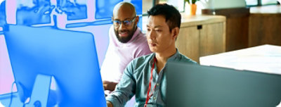 A man with a beard looking at a computer screen.