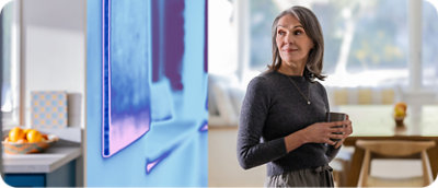 A woman standing next to a painting.