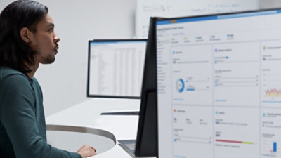 A person sitting at a desk with a computer screen.