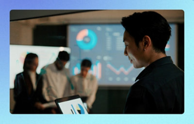 A man is looking at the laptop displaying graphs.