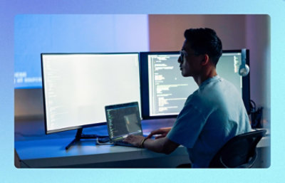 A person sitting at a desk with a laptop.