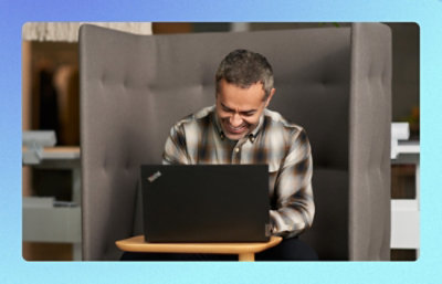 A person sitting in a chair using a laptop.