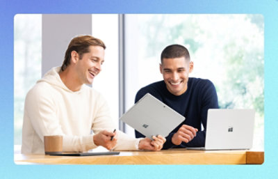 Two men looking at laptops.