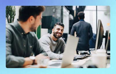 A group of people sitting at a table with a laptop.