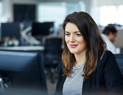 A woman looking at a computer.