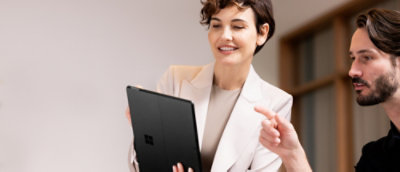 A men and women looking at a tab.