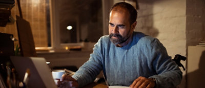 A man working on a laptop.