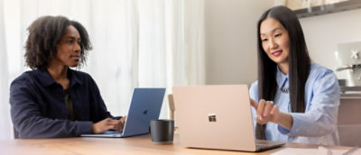 Two people working on their laptops.
