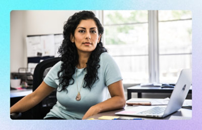 Person seated at desk with laptop and documents in a home office
