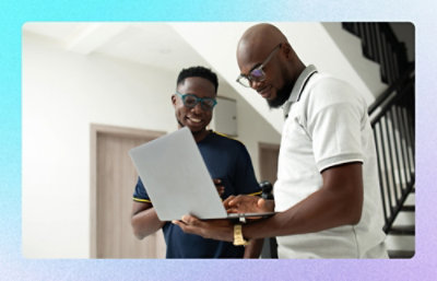 Two colleagues reviewing information together on a laptop in an indoor workspace