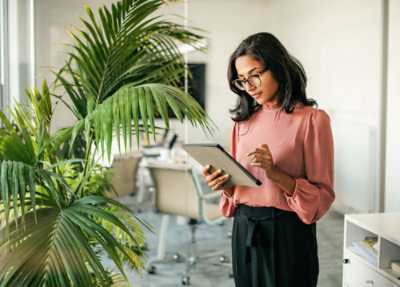 A woman working on tablet.