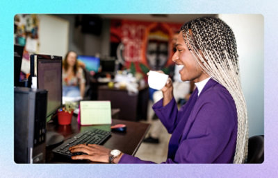 A man working on laptop while sipping a beverage.