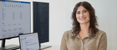 Women smilling and sitting beside the screens