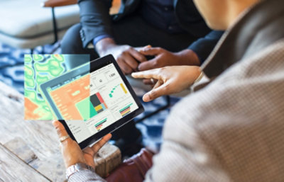 A man showing a tab screen to a other person.
