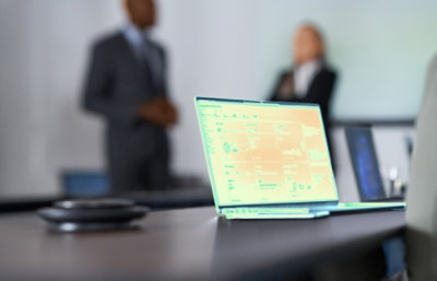 A man and a women speaking together in office.