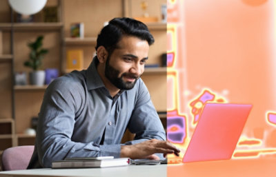 A person sitting at a desk using a laptop.