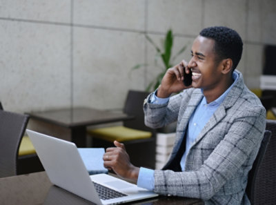 A man in a suit talking on a cell phone.