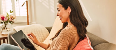 A woman is looking at a computer screen.