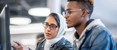 A woman is looking at a computer screen.