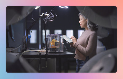 A woman holding a clipboard near a yellow and black machine.