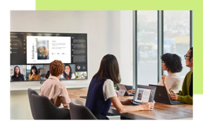 A group of people sitting in conference room and discussing by looking at screen
