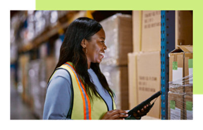 A lady is looking at parcel boxes and smiling