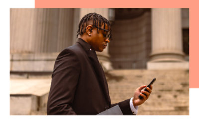 A man standing and looking at phone