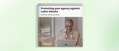 A man at looking at a laptop.