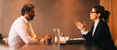 A man and woman using a computer and discussing.