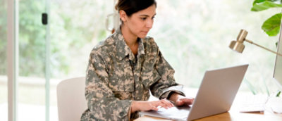 A woman is working on a laptop