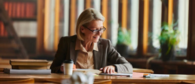 A woman looking at phone and laughing