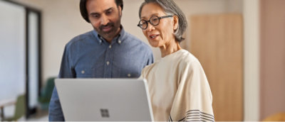 A people discussing something using a laptop.