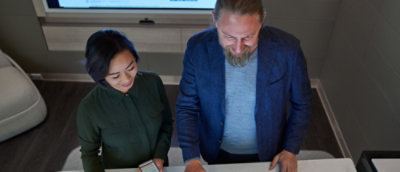 A man and woman looking at a computer screen.