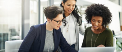 Three people checking something in the tablet