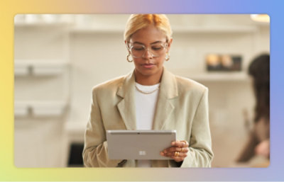 A women Holding a tab and looking into it.