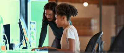 Two peoples are looking on the screen