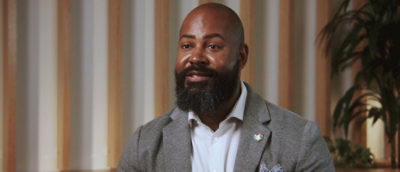 A man wearing suit looking at the camera and smiling