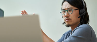 A man wearing specs explaining something