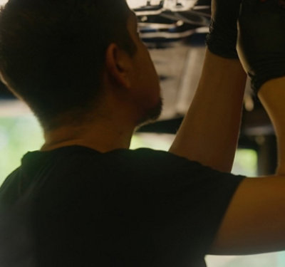 A man wearing glous and working.