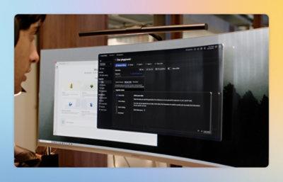 Close-up of a curved monitor displaying a chat playground interface and a settings window in a modern workspace.