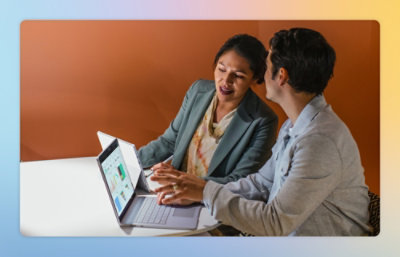 A person using a laptop at a table.
