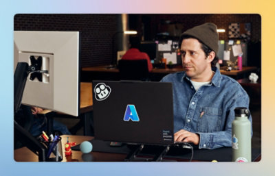 A person sitting at a desk with a computer.