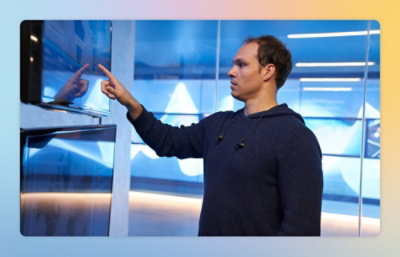 A person pointing at a screen.